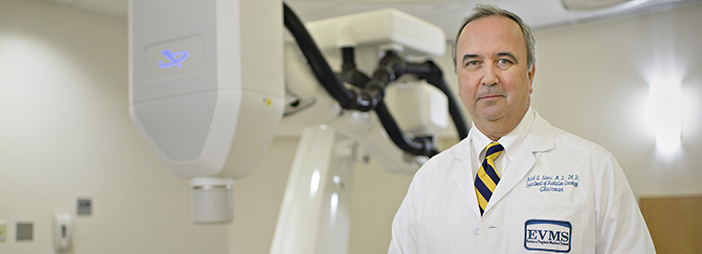 An EVMS doctor standing in front of equipment